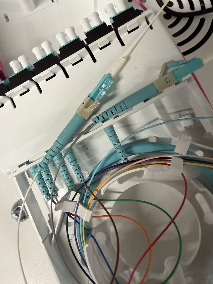 Color-coded fiber strands routed to LC pigtails